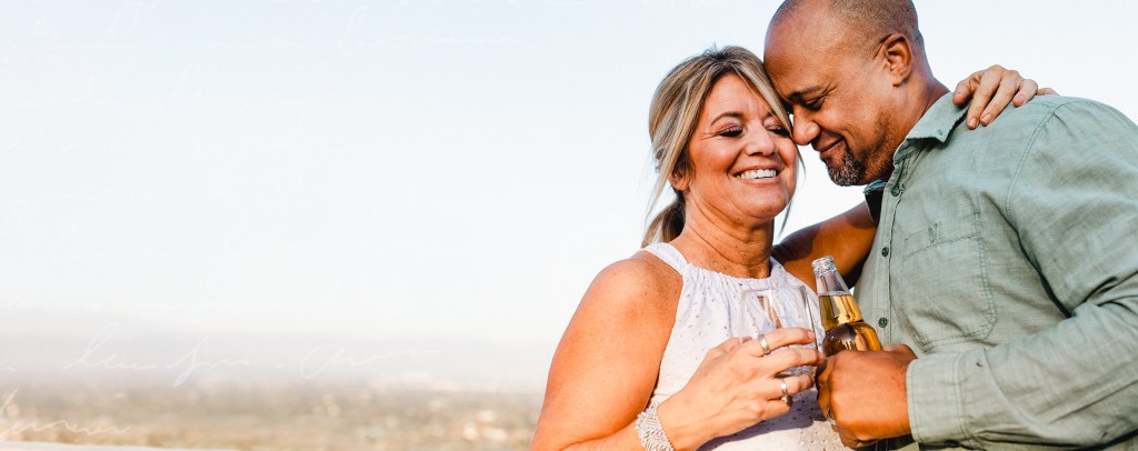 couple embracing with celebratory drinks